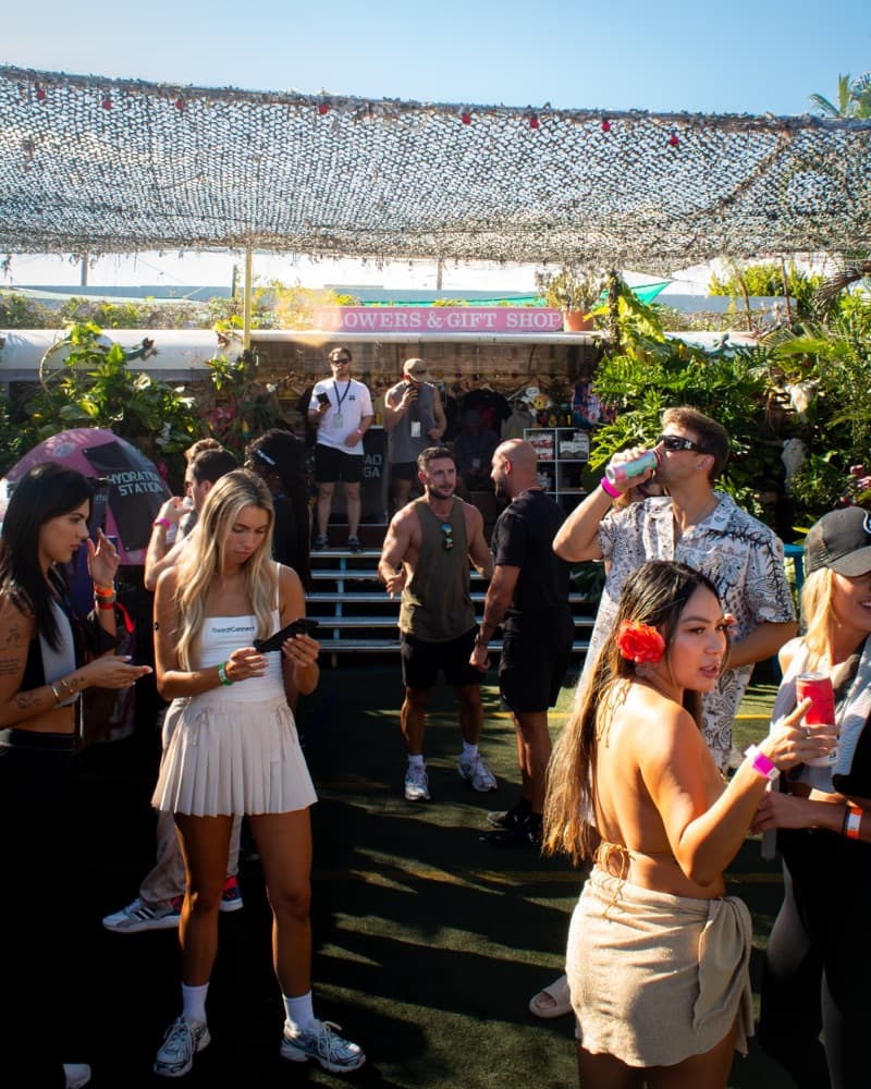 Guests mingling with drinks at an outdoor event