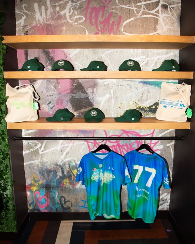 Branded caps, tote bags and jerseys on a merch wall